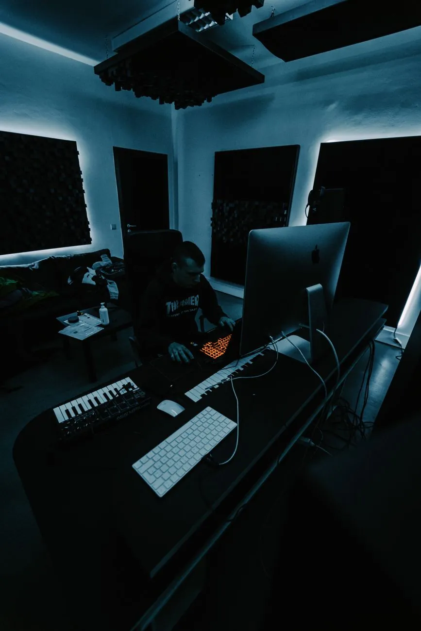 Developer working late by the glow of a monitor in a dark room